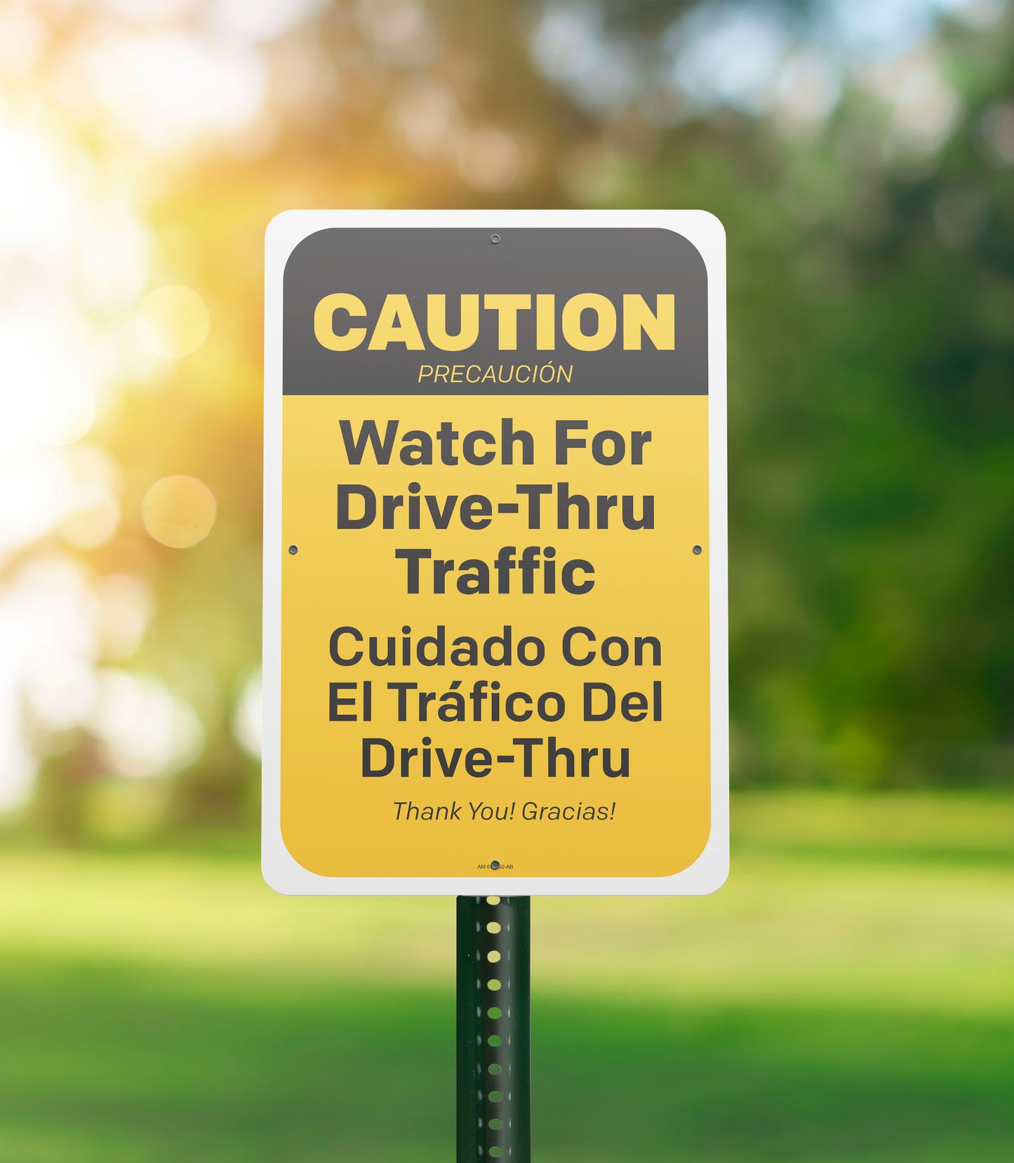 Caution sign warning about drive-thru traffic with trees in the background