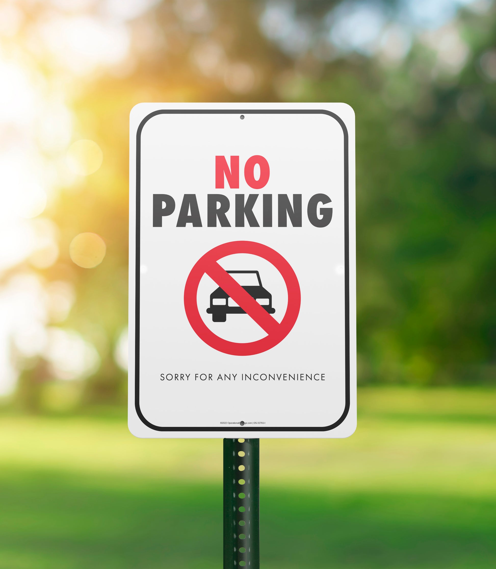 white black and red no parking sorry for inconvenience with trees in background