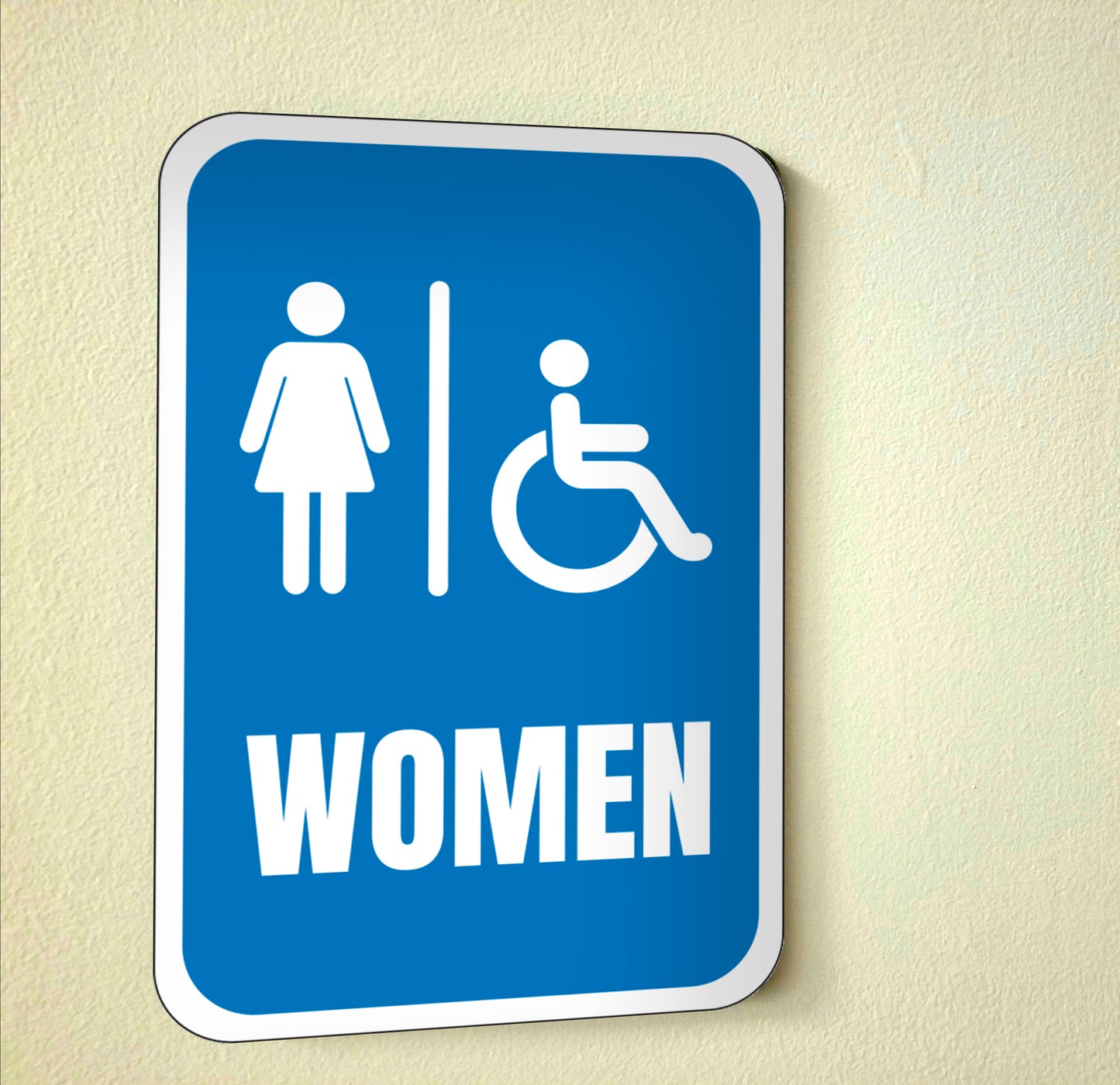 blue and white handicap accessible womens restroom sign on wall