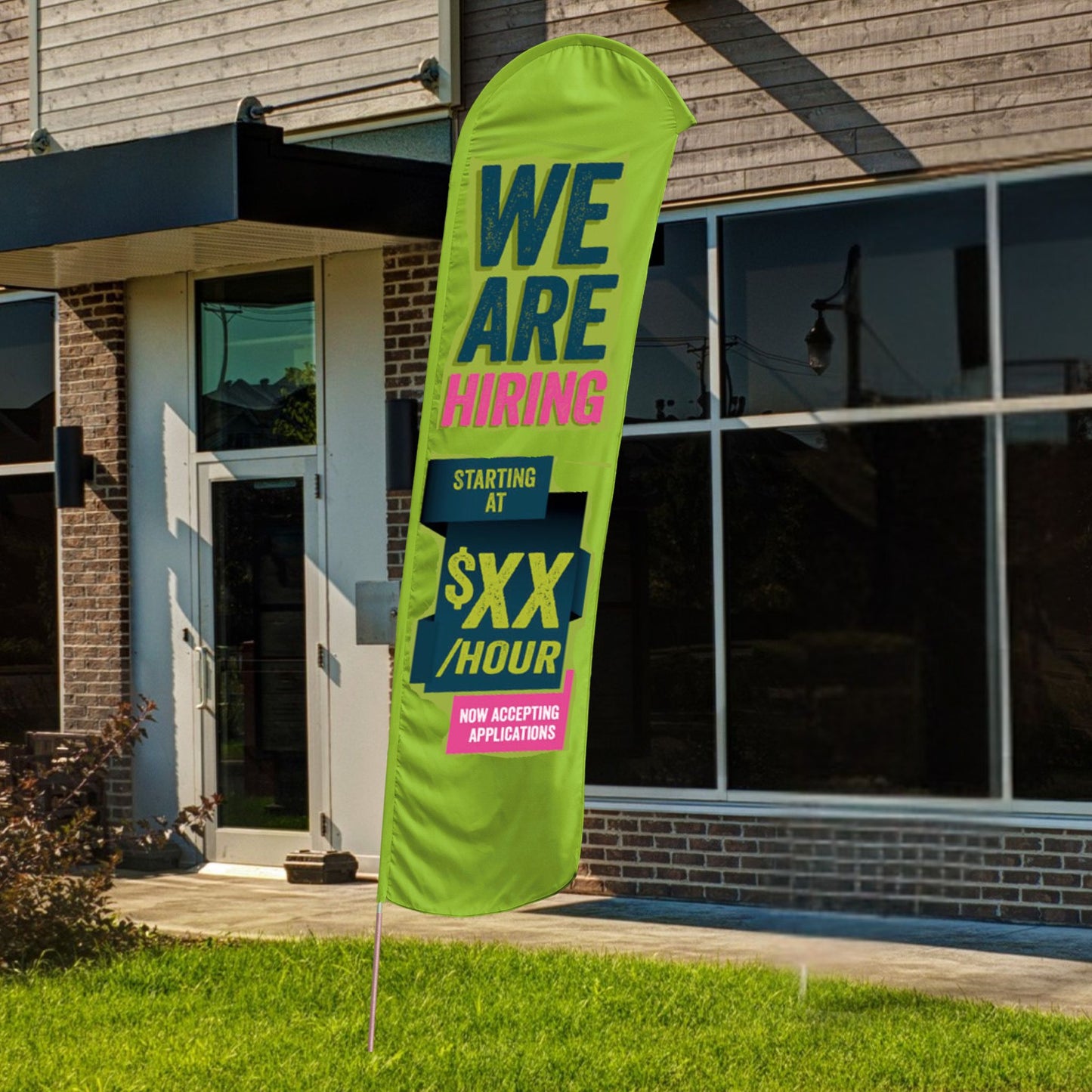 custom green and pink we are hiring blade flag in front of building