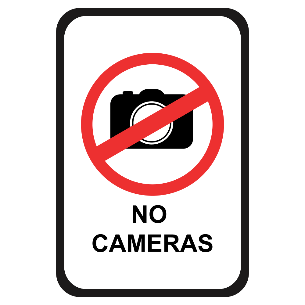 white sign with black outline with a prohibited symbol over a black camera with black letters that say no cameras