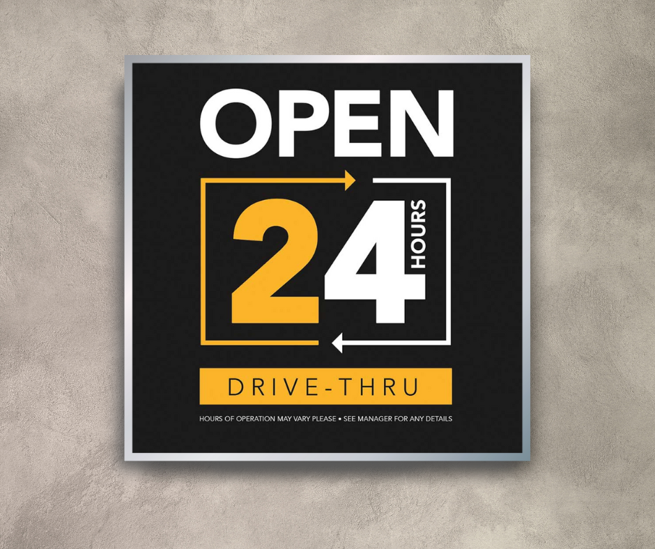 black white and yellow 24 hour drive thru mini billboard on cement wall