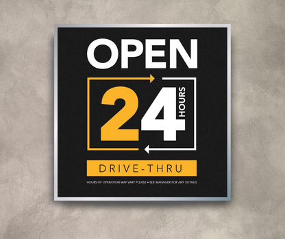 black white and yellow 24 hour drive thru mini billboard on cement wall