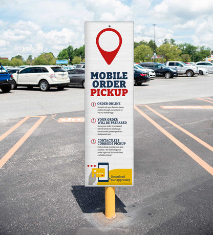 Mobile order pickup sign in a parking lot with cars in the background