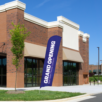 blue and white grand opening blade flag in front of building