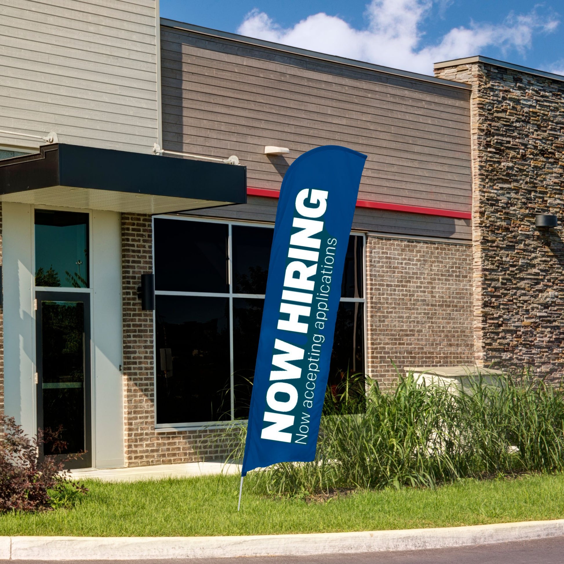 blue and white now hiring blade flag in front of building