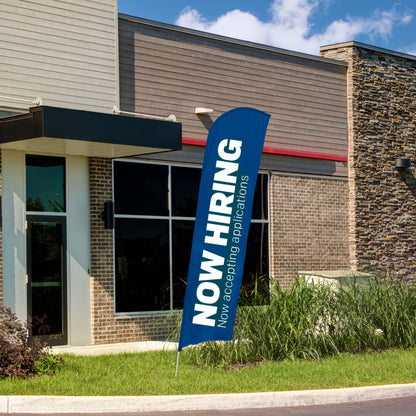blue and white now hiring blade flag in front of building