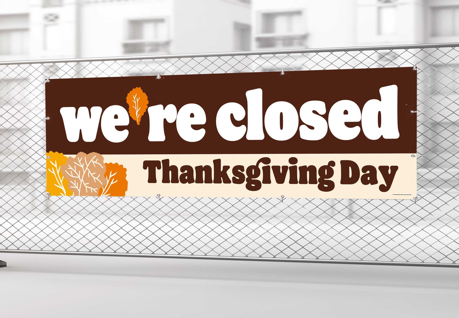 Closed sign for Thanksgiving Day on a chain-link fence.