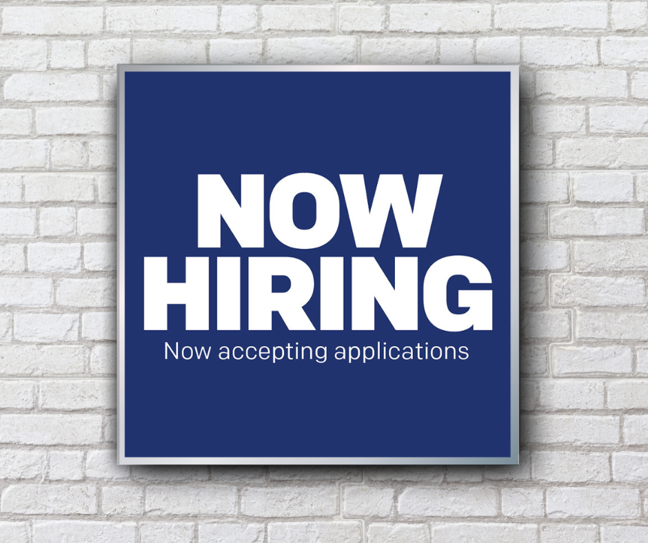 blue now hiring mini billboard on white brick wall