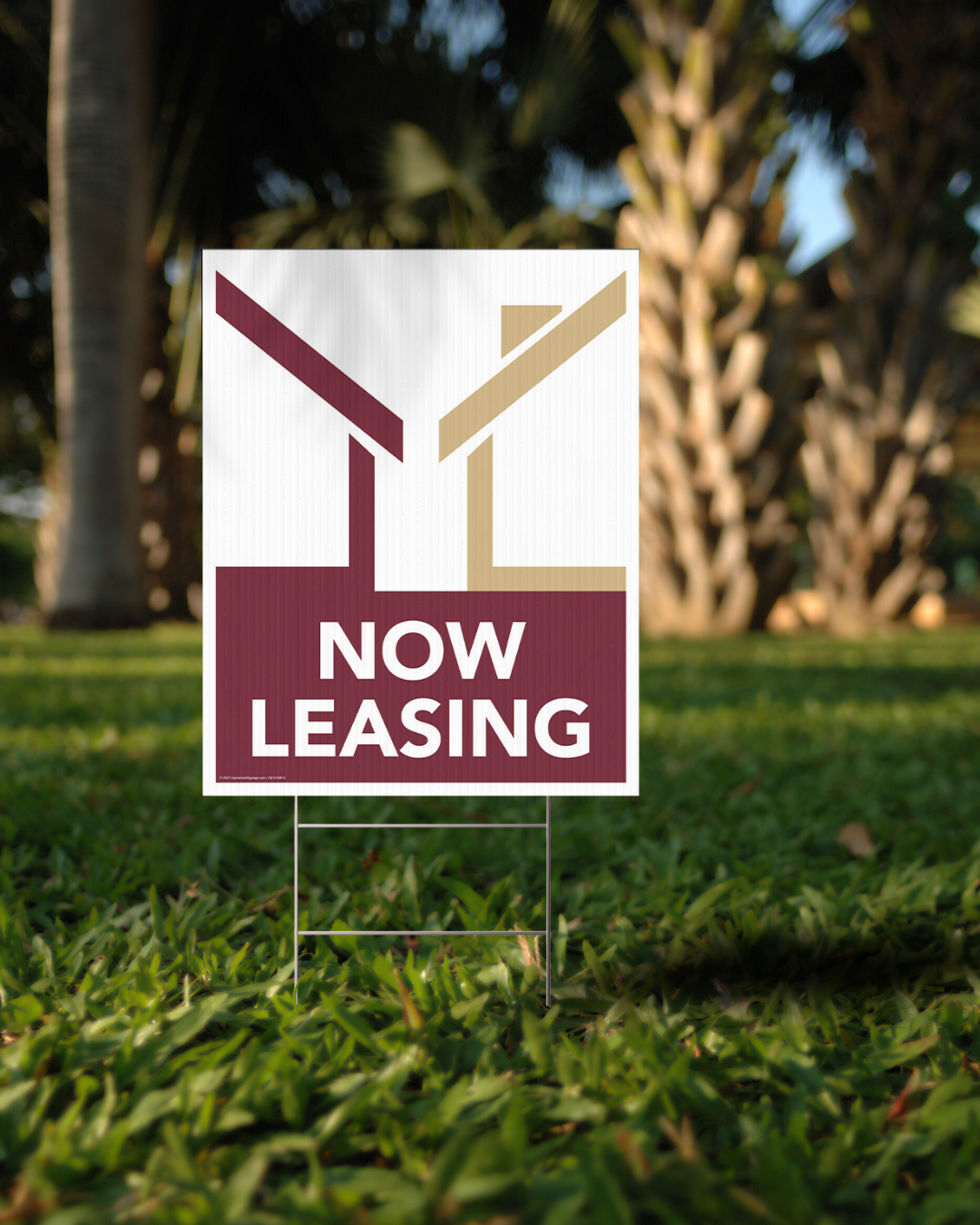now leasing lawn sign garnet white gold in front of palm tree