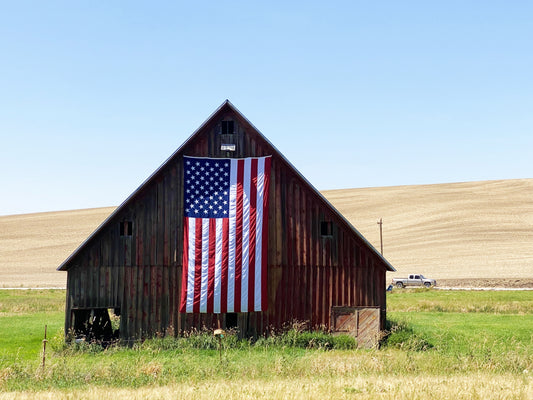 us flag 10 ft by 15 ft on brown barn with green field