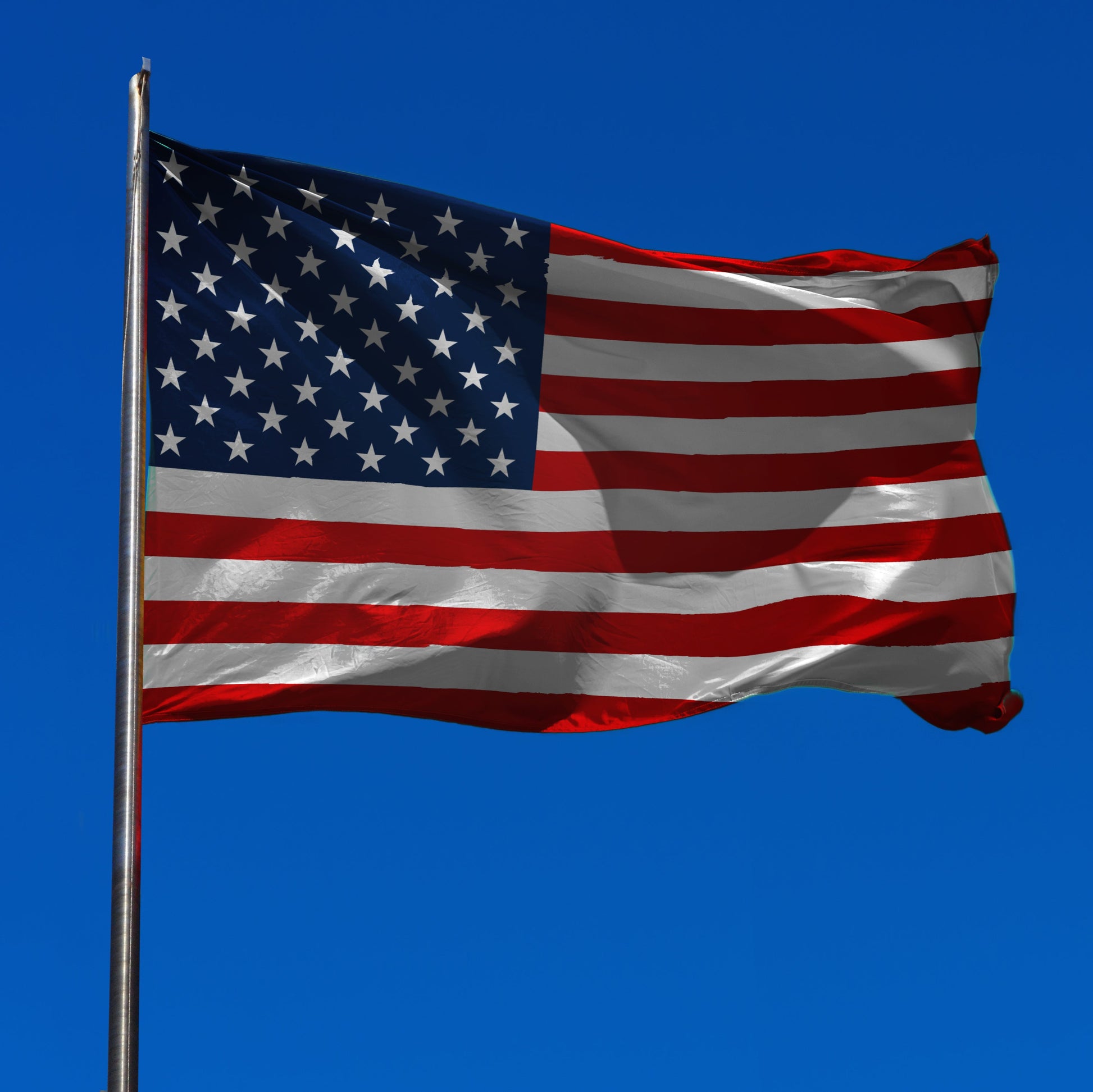 us flag on pole with sky background