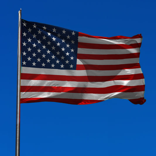 us flag on pole with sky background