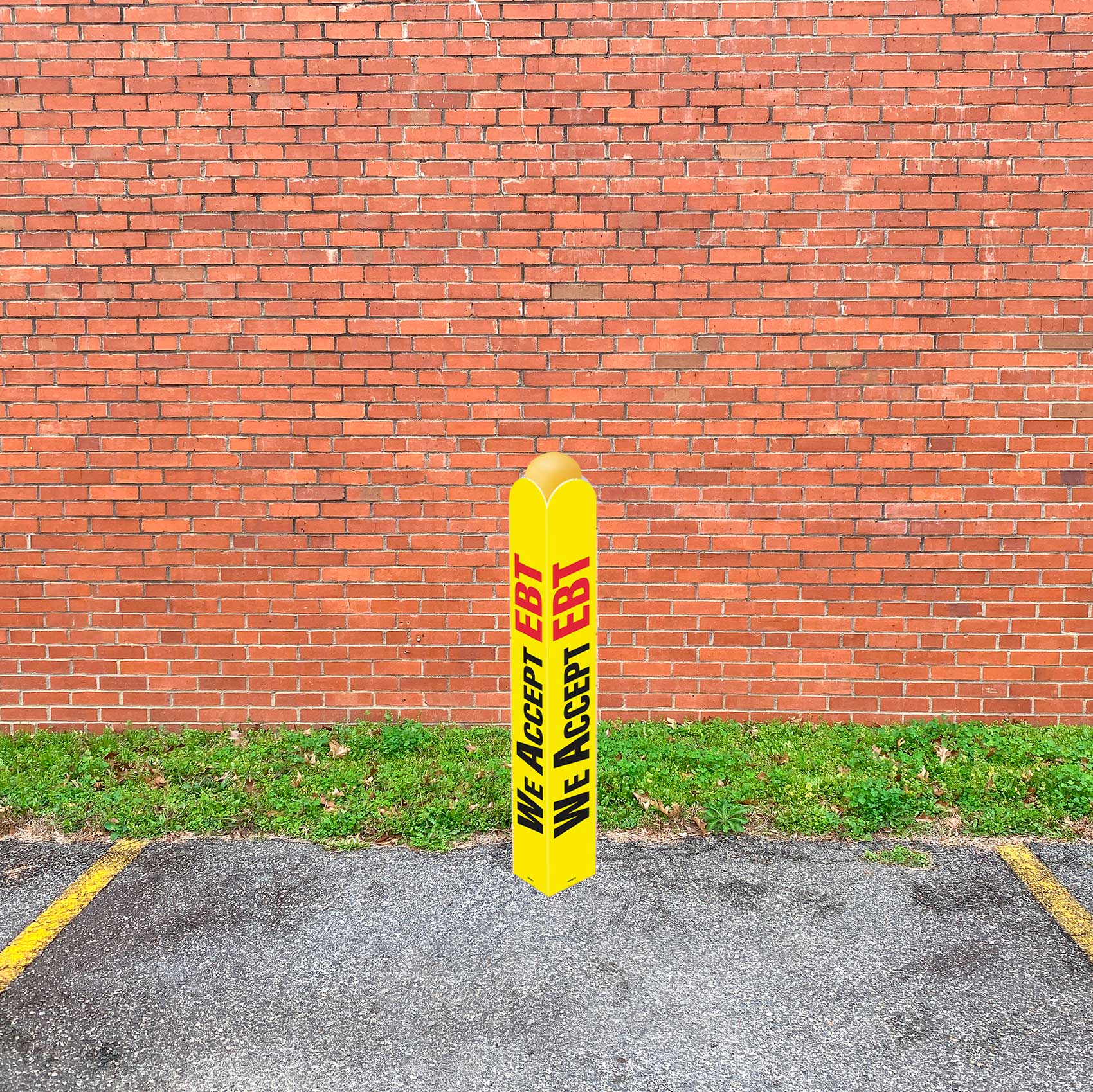 Yellow bollard with sign that says "WE ACCEPT EBT" 