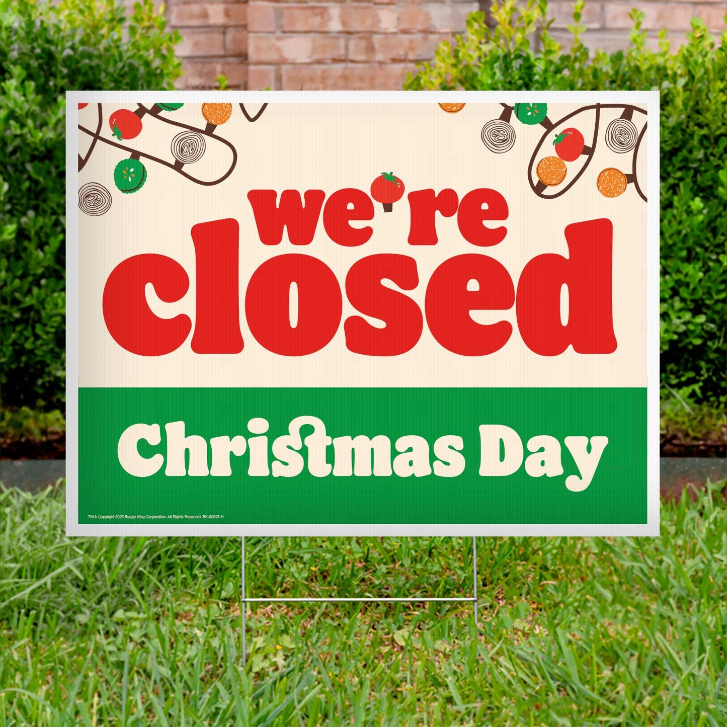 Closed Christmas Day sign on grass with festive decorations