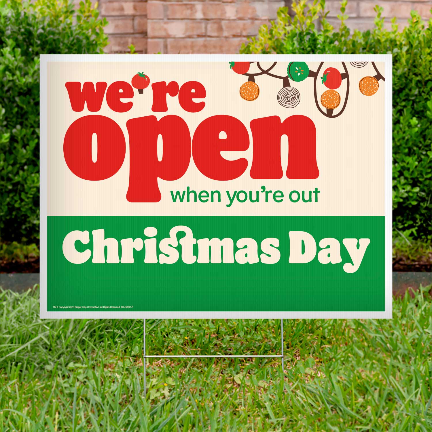 Christmas Day open sign on grass with festive decorations