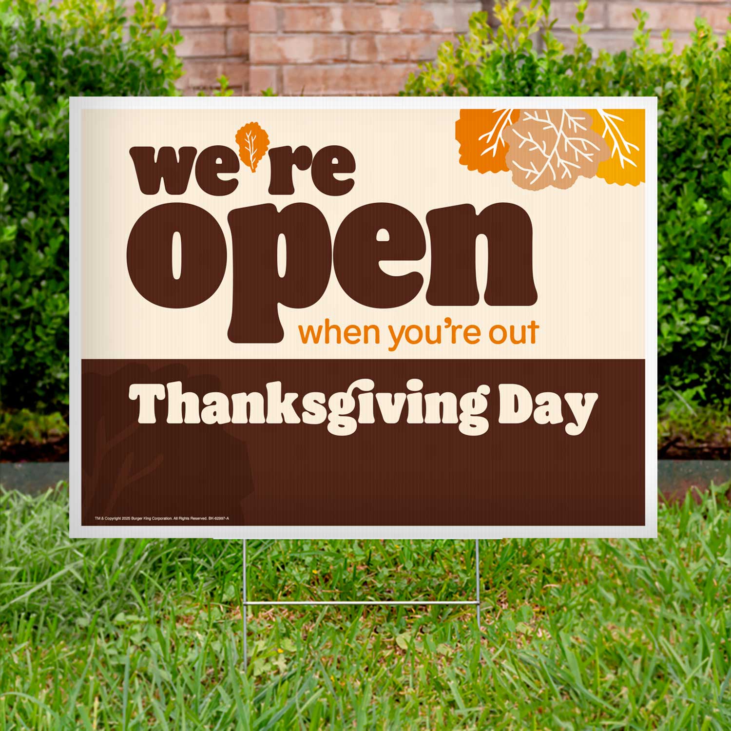 Outdoor sign on grass with 'we're open when you're out Thanksgiving Day' text